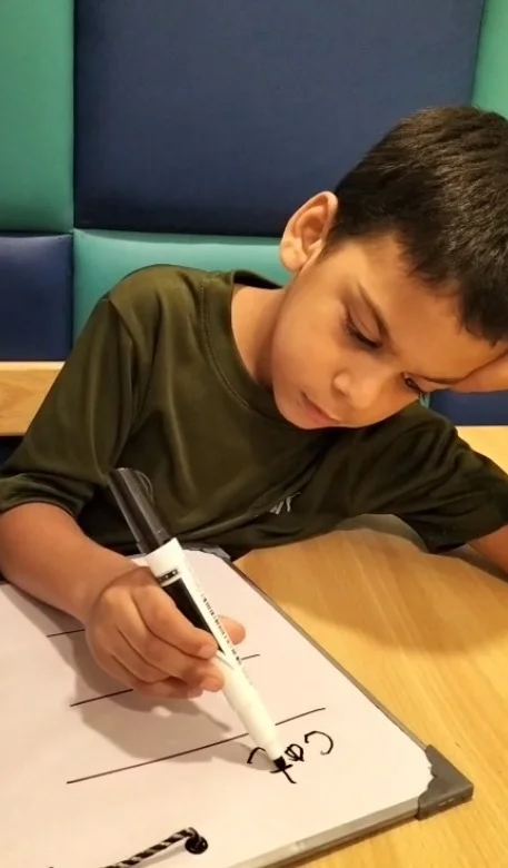Child practicing table-top communication and learning activities